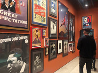  Visitors to the Academy Museum of Motion Pictures Arts and Sciences in Los Angeles, California, examine movie posters from Spike Lee's personal collection. Photo courtesy of Bill Neely. 