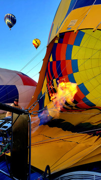  A balloonist in Temecula, California, fires up the burner that will cause his balloon to inflate. Photo courtesy of Jim Farber. 