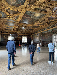 . Guests absorb the impact of powerful gold friezes above the Great Council's meeting room in Venice's famed Doge's Palace. Photo courtesy of Lesley Sauls Frederikson. 