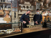  Local Prosecco is poured at Cantina do Mori beneath metal pails that were once used to gather fresh water. Photo courtesy of Lesley Sauls Frederikson. 