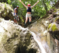 A visitor to Puerta Plata in the Dominican Republic prepares to tackle a natural waterslide as part of an Iguana Mama excursion. Photo courtesy of Iguana Mama.