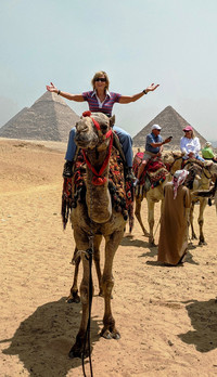  The author rides a camel at the Pyramids of Giza in Egypt. Photo courtesy of Victor Block. 