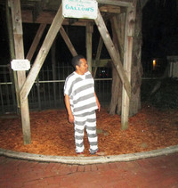  A costumed interpreter at the Hanging Jail in St. Augustine, Florida, tells members of a ghost tour about events that took place there in the past. Photo courtesy of Victor Block. 