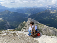  A hiker in Italy's Dolomite Mountains takes a break to enjoy the scenery. Photo courtesy of Margot Black. 