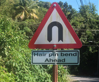  Signs warning of hairpin turns are frequent on roads in St. Lucia. Photo courtesy of Victor Block. 