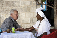 A Road Scholar tour participant interacts with a woman in Cuba. Photo courtesy of Road Scholar. 