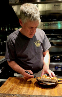  Chef Steven Kniffen serves up a fresh seafood dinner at the Sea Chest Oyster Bar in Cambria, California. Photo courtesy of Jim Farber. 