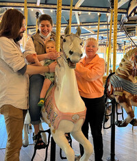 . A family enjoys the carousel at Peddler's Village in Lahaska, Pennsylvania. Photo courtesy of Bill Neely.