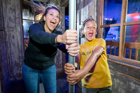 Visitors to WonderWorks in Branson, Missouri, try to withstand the force of a hurricane. Photo courtesy of WonderWorks.