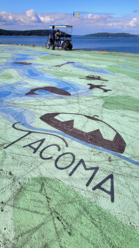 The waterfront promenade at Point Ruston is accentuated by an artistic orca-embedded map of Tacoma, Washington, and Puget Sound. Photo courtesy of Jim Farber.