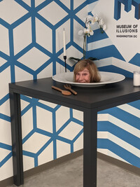 . A visitor to the Museum of Illusions in Washington, D.C., appears to have her head served up on a platter. Photo courtesy of Elle Kendall.