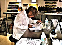 A visitor to the original Tijon parfumerie on St. Martin plays chemist and concocts her own scent. Photo courtesy of Victor Block.