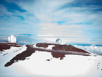. Skiers who arrive at the top of Mauna Kea in Hawaii are greeted by the site of telescopes where astronomers study space from this isolated point. Photo courtesy of Wirestock/Dreamstime.com. 