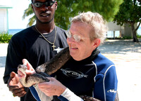 An Oceanic Society volunteer in Belize meets up with two types of locals. Photo courtesy of the Oceanic Society. 