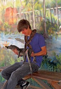  The authors' grandson, Alex, holds a ball python at Gatorland in Orlando, Florida. Photo courtesy of Bill Neely. 