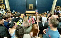  Visitors in a crowd at the Louvre Museum in Paris, France, attempt to photograph the "Mona Lisa." Photo courtesy of Andrew Sutherland/Dreamstime.com. 