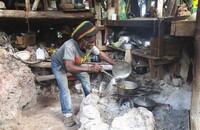  Fire, who left civilization 33 years ago, makes lunch for guests on a mountaintop near Negril, Jamaica. Photo courtesy of Victor Block. 