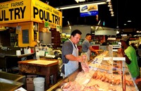  Workers in a shop at Baltimore's Lexington Market wrap up poultry for a customer. Photo courtesy of Lei Xu/Dreamstime.com. 