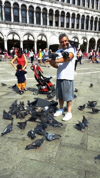  A man feeds the pigeons at Piazza San Marco in Venice, Italy. Photo courtesy of Victor Block. 