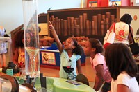 Children watch a water funnel in the stream table at the Delaware Children's Museum in Wilmington. Photo courtesy of Wilmington Convention and Visitors Bureau.
