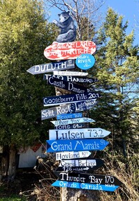  The North Shore distance sign outside the Great Lakes Candy Kitchen points the way to Grand Marais, Minnesota. Photo courtesy of Cheryl Thiede. 