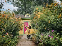  A child explores a tiny house at Bookworm Gardens in Sheboygan, Wisconsin. Photo courtesy of Pakou Lo. 