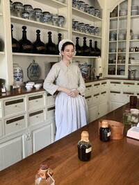 A guide answers visitors' questions at an apothecary in Colonial Williamsburg, Virginia. Photo courtesy of Sharon Whitley Larsen. 