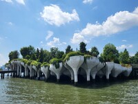  Tulip-shaped concrete pots that bloom with greenery blend architecture and nature at New York's Little Island park, designed by Thomas Heatherwick. 