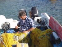  The author helped this Greek fisherman mend his nets. Photo courtesy of Victor Block. 