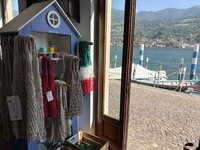  Nets hang in a maker's workshop with Lake Iseo in the background. Photo courtesy of Alison Ramsey. 