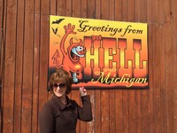 Visitors to Hell, Michigan, can't resist having their pictures taken by a sign that advertises the town's unusual name. Photo courtesy of Hell, Michigan.