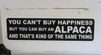 A sign near the Cabin View Alpaca Farm in Seneca County, New York, tempts travelers to turn in and learn what happens there. Photo courtesy of Victor Block.