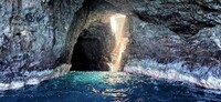 Sunlight hits a waterfall in a grotto along the Na Pali coast of Kaua'i, Hawaii. Photo courtesy of Jim Farber.