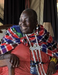  A Maasai storyteller entertains visitors to the Serengeti through an interpreter. Photo courtesy of Lesley Frederikson. 