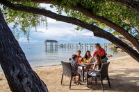  A family dines on the sand at popular Marker 88, where fish tacos are the order of the day. Photo courtesy of Visit Florida Keys. 