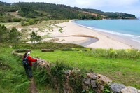 A hiker overlooks the beach in Finnestere, Spain. Photo courtesy of Doug Hansen.