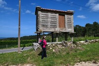 A hiker in Spain passes by a horreo used to store grain during the winter months. Photo courtesy of Doug Hansen.