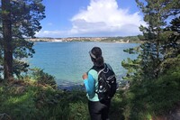 A hiker checks out an intriguing trail with a view to a small Spanish village across the bay. Photo courtesy of Doug Hansen.