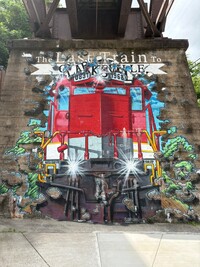 Artist Ricky Cavaness' "Last Train to Clarksville" mural bursts from the support pillar of the old train bridge in downtown Clarksville, Tennessee. Photo courtesy of Alison Ramsey.