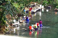 Maya women do their laundry in a river near Placencia in Belize. Photo courtesy of Phil Allen.