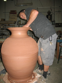  Dan Toberer completes a massive ceramic pot in his studio at the Hot Shops Art Center in Omaha, Neb. Photo courtesy of Glenda Winders. 