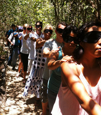  Participants in a Sense Adventure Tour in Riviera Maya, Mexico, stay together by holding onto the shoulder of the person in front of them. Photo courtesy of Fyllis Hockman. 