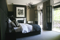  Masculine minimalism: A work-of-art fixture lights a khaki, black and cool bedroom. Photo courtesy of Kenneth Cobonpue. 