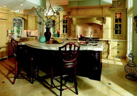 Pass the cream? Contrasting with warm-white cabinets, the dark center island becomes the locus of a kitchen meant for entertaining. Photo: Courtesy Plain and Fancy Cabinetry.