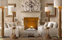 Quartet of imposing floor lamps sheds light on a mirror-image seating area arranged in front of the fireplace. Photo courtesy of Restoration Hardware.