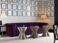  The sum is truly greater than its parts when many artworks are hung in precise rows over a sofa. Photo Courtesy Baker Furniture. 