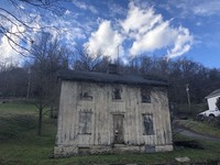  An abandoned house sits along the long-defunct Pittsburgh and Lake Erie Railroad line. 