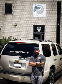 Craig Hettlinger stands in front of the Huntington Addiction Wellness Center he founded to help bridge the gap in the recovery community. Photo courtesy of Craig Hettlinger. 
