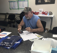 Ken Miller fills out the state election form to change his voter registration from Democrat to Republican. Photo credit Salena Zito.