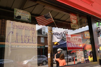Signs blaring "Help Wanted" and "Temporarily Closed" have appeared all over the Strip District. Photo credit Justin Merriman.